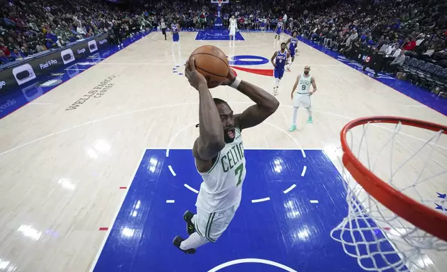 Boston Celtics' Jaylen Brown goes up for a dunk during the second half of an NBA basketball game against the Philadelphia 76ers, Thursday, Feb. 20, 2025, in Philadelphia. (AP Photo/Matt Slocum)