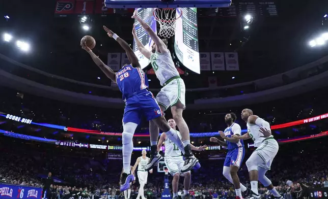 Philadelphia 76ers' Guerschon Yabusele, left, goes up for a shot against Boston Celtics' Luke Kornet during the first half of an NBA basketball game, Thursday, Feb. 20, 2025, in Philadelphia. (AP Photo/Matt Slocum)