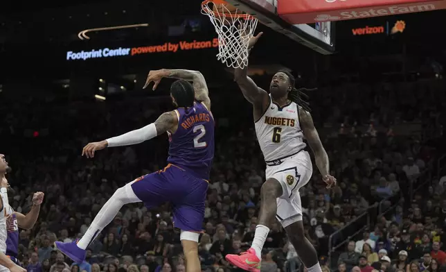 Denver Nuggets center DeAndre Jordan (6) scores over Phoenix Suns center Nick Richards (2) during the first half of an NBA basketball game, Saturday, Feb. 8, 2025, in Phoenix. (AP Photo/Rick Scuteri)