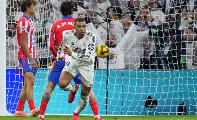 Real Madrid's Kylian Mbappe celebrates after scoring his side's first goal during a Spanish La Liga soccer match between Real Madrid and Atletico Madrid at the Santiago Bernabeu stadium in Madrid, Saturday, Feb. 8, 2025. (AP Photo/Manu Fernandez)