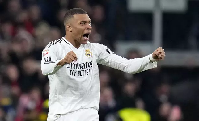 Real Madrid's Kylian Mbappe celebrates after scoring his side's first goal during a Spanish La Liga soccer match between Real Madrid and Atletico Madrid at the Santiago Bernabeu stadium in Madrid, Saturday, Feb. 8, 2025. (AP Photo/Manu Fernandez)