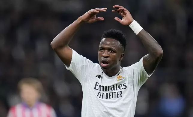 Real Madrid's Vinicius Junior reacts after a failed attempt to score during a Spanish La Liga soccer match between Real Madrid and Atletico Madrid at the Santiago Bernabeu stadium in Madrid, Saturday, Feb. 8, 2025. (AP Photo/Manu Fernandez)