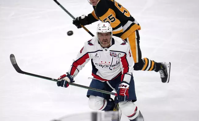 Washington Capitals' Alex Ovechkin (8) watches an airborne puck after a face-off during the first period of an NHL hockey game against the Pittsburgh Penguins in Pittsburgh, Saturday, Feb. 22, 2025. (AP Photo/Gene J. Puskar)