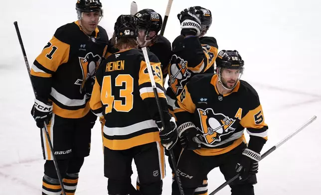 Pittsburgh Penguins' Kris Letang (58) heads back to his bench after scoring during the first period of an NHL hockey game against the Washington Capitals in Pittsburgh, Saturday, Feb. 22, 2025. (AP Photo/Gene J. Puskar)