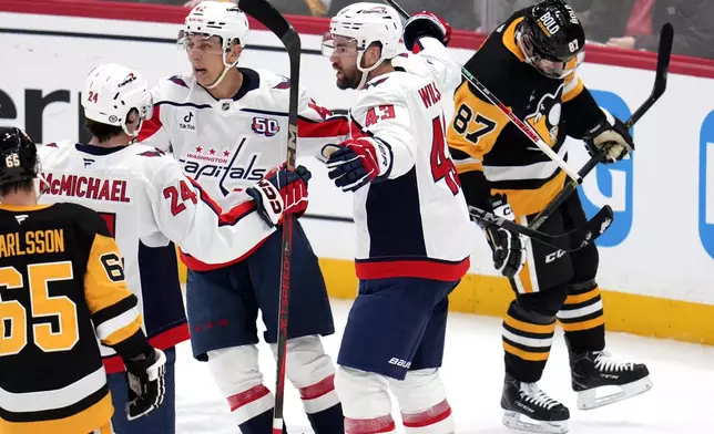 Washington Capitals' Tom Wilson (43) celebrates his goal during the second period of an NHL hockey game against the Pittsburgh Penguins in Pittsburgh, Saturday, Feb. 22, 2025. (AP Photo/Gene J. Puskar)