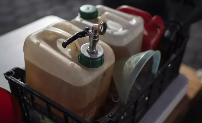 Containers filled with Petgas gasoline, produced from plastic, are seen at the Petgaserita plant in Boca del Rio, Veracruz, Mexico, Jan. 4, 2025. (AP Photo/Felix Marquez)