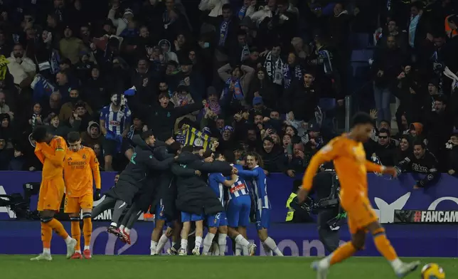 Espanyol players celebrate after Carlos Romero scored the opening goal during a Spanish La Liga soccer match between Espanyol and Real Madrid at the Lluis Companys Olympic Stadium in Barcelona, Spain, Saturday Feb.1, 2025. (AP Photo/Joan Monfort)