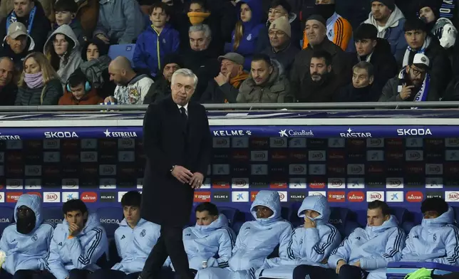 Real Madrid's head coach Carlo Ancelotti watches the play in front of the substitutes bench during a Spanish La Liga soccer match between Espanyol and Real Madrid at the Lluis Companys Olympic Stadium in Barcelona, Spain, Saturday Feb.1, 2025. (AP Photo/Joan Monfort)