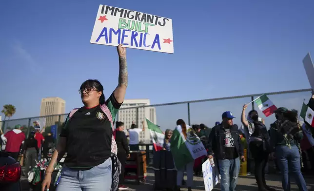 A demonstrator holds a sign during a protest calling for immigration reform Sunday, Feb. 2, 2025, in Los Angeles. (AP Photo/Eric Thayer)