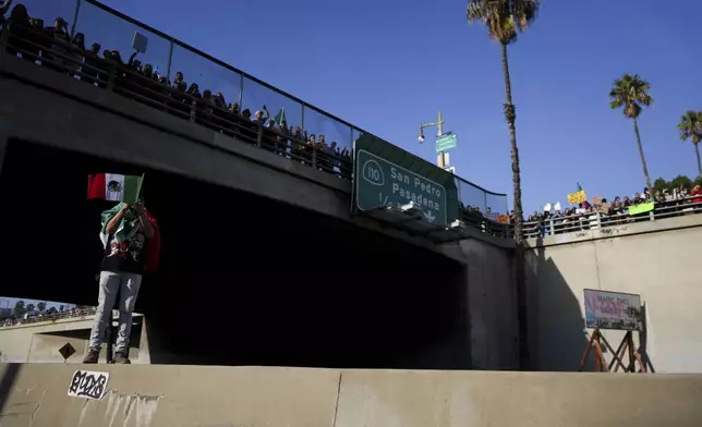 Demonstrators shut down the 110 freeway during a protest calling for immigration reform Sunday, Feb. 2, 2025, in Los Angeles. (AP Photo/Eric Thayer)