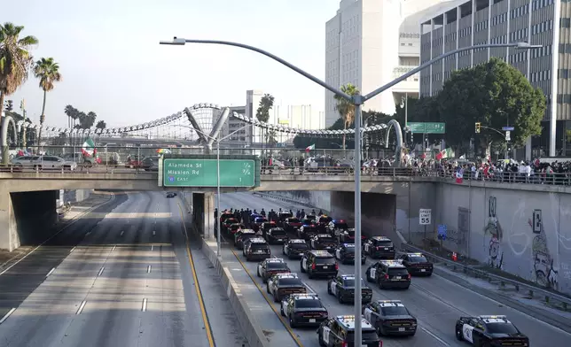 Law enforcement personnel stage on the 110 freeway during a protest calling for immigration reform Sunday, Feb. 2, 2025, in Los Angeles. (AP Photo/Eric Thayer)