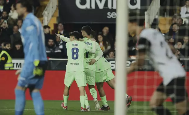 Barcelona's Ferran Torres celebrates the opening goal during a Spanish Copa del Rey, or King's Cup, quarter-final soccer match between Valencia and Barcelona at the Mestalla Stadium in Valencia, Spain, Thursday Feb. 6, 2025. (AP Photo/Alberto Saiz)