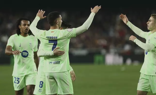 Barcelona's Ferran Torres celebrates his side's fourth goal during a Spanish Copa del Rey, or King's Cup, quarter-final soccer match between Valencia and Barcelona at the Mestalla Stadium in Valencia, Spain, Thursday Feb. 6, 2025. (AP Photo/Alberto Saiz)