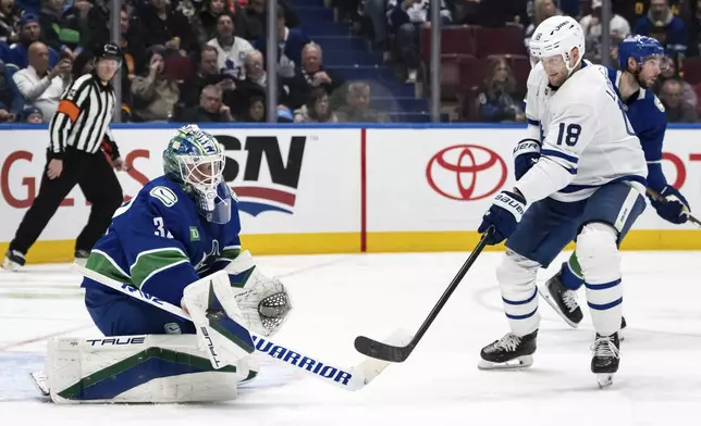Vancouver Canucks goaltender Kevin Lankinen (32) stops Toronto Maple Leafs' Steven Lorentz (18) during the second period of an NHL hockey game in Vancouver, on Saturday, Feb. 8, 2025.(Ethan Cairns/The Canadian Press via AP)