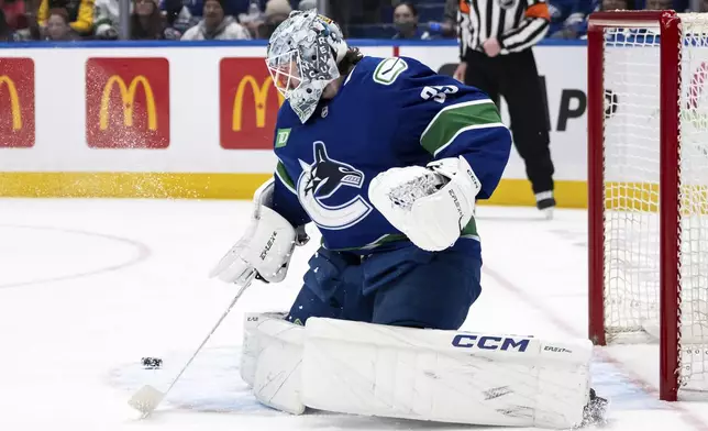 Vancouver Canucks goaltender Thatcher Demko (35) stops the puck during the first period of an NHL hockey game against the Toronto Maple Leafs in Vancouver, British Columbia, Saturday, Feb. 8, 2025. (Ethan Cairns/The Canadian Press via AP)