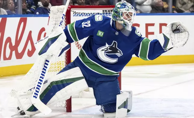 Vancouver Canucks goaltender Kevin Lankinen stops the puck against the Toronto Maple Leafs during the second period of an NHL hockey game in Vancouver, British Columbia, Saturday, Feb. 8, 2025. (Ethan Cairns/The Canadian Press via AP)
