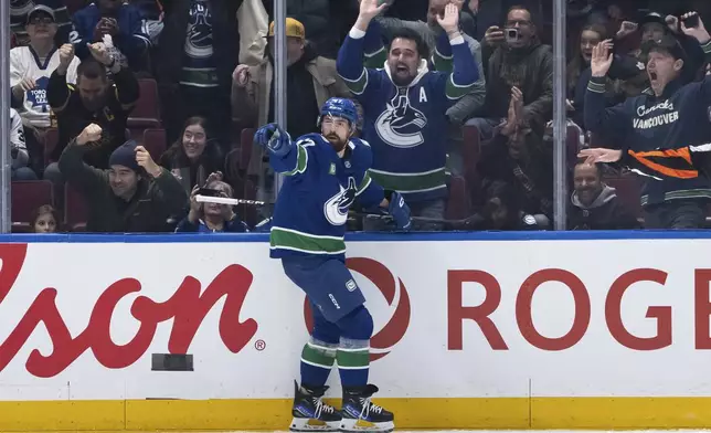 Vancouver Canucks' Filip Hronek (17) celebrates after his goal against the Toronto Maple Leafs during the first period of an NHL hockey game in Vancouver, British Columbia, Saturday, Feb. 8, 2025. (Ethan Cairns/The Canadian Press via AP)