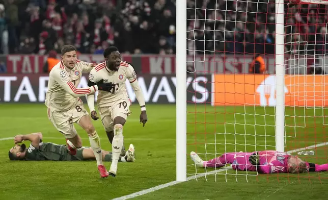 Bayern's Alphonso Davies, centre, celebrates after scoring his side's opening goal during the Champions League playoff second leg soccer match between FC Bayern Munich and Celtic Glasgow at the Allianz Arena in Munich, Germany, Tuesday, Feb. 18, 2025. (AP Photo/Matthias Schrader)