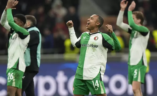 Feyenoord's Igor Paixao players celebrates with teammates after the Champions League, playoff second leg soccer match between AC Milan and Feyenoord, at the San Siro stadium in Milan, Italy, Tuesday, Feb.18, 2025. (AP Photo/Luca Bruno)