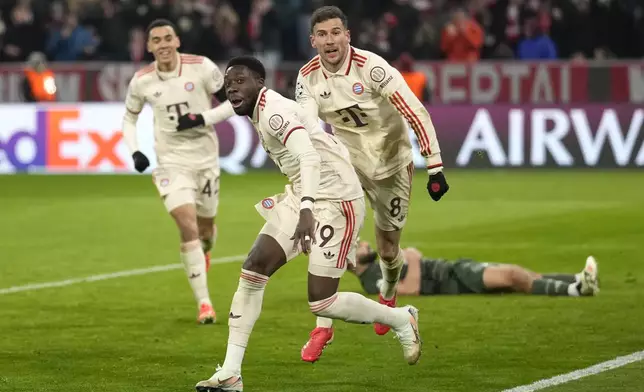 Bayern's Alphonso Davies, centre, celebrates after scoring his side's opening goal during the Champions League playoff second leg soccer match between FC Bayern Munich and Celtic Glasgow at the Allianz Arena in Munich, Germany, Tuesday, Feb. 18, 2025. (AP Photo/Matthias Schrader)