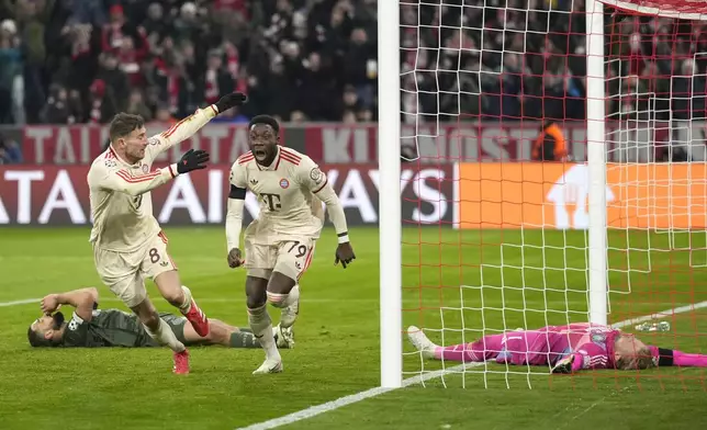 Bayern's Alphonso Davies, centre, celebrates after scoring his side's opening goal during the Champions League playoff second leg soccer match between FC Bayern Munich and Celtic Glasgow at the Allianz Arena in Munich, Germany, Tuesday, Feb. 18, 2025. (AP Photo/Matthias Schrader)