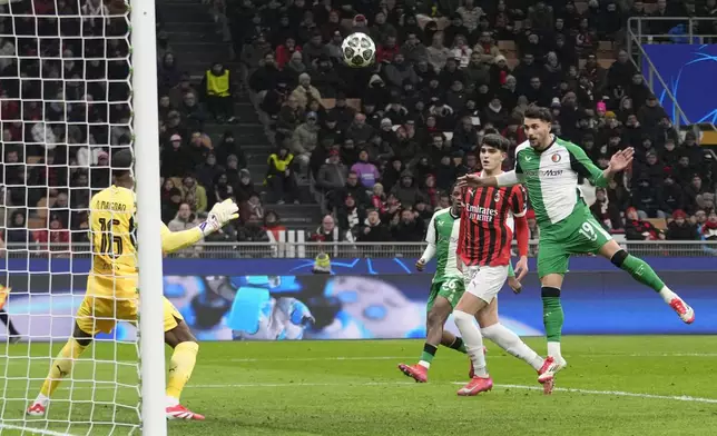 Feyenoord's Julian Carranza scores his side's first goal during Champions League, playoff second leg soccer match between AC Milan and Feyenoord, at the San Siro stadium in Milan, Italy, Tuesday, Feb.18, 2025. (AP Photo/Luca Bruno)