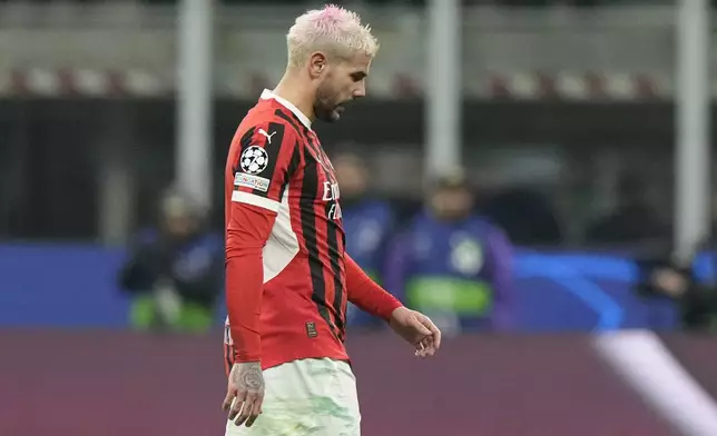 AC Milan's Theo Hernandez leaves the pitch after being sent off by Referee Szymon Marciniak of Poland after his second yellow card during Champions League, playoff second leg soccer match between AC Milan and Feyenoord, at the San Siro stadium in Milan, Italy, Tuesday, Feb.18, 2025. (AP Photo/Luca Bruno)