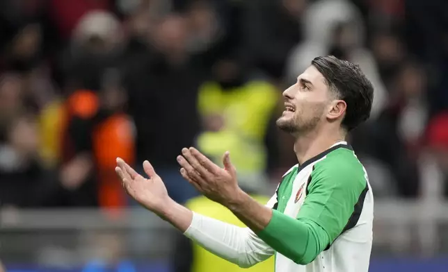 Feyenoord's Julian Carranza celebrates after scoring his side's first goal during Champions League, playoff second leg soccer match between AC Milan and Feyenoord, at the San Siro stadium in Milan, Italy, Tuesday, Feb.18, 2025. (AP Photo/Luca Bruno)
