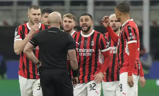 AC Milan's players argue with Referee Szymon Marciniak of Poland after he sent off AC Milan's Theo Hernandez during Champions League, playoff second leg soccer match between AC Milan and Feyenoord, at the San Siro stadium in Milan, Italy, Tuesday, Feb.18, 2025. (AP Photo/Luca Bruno)