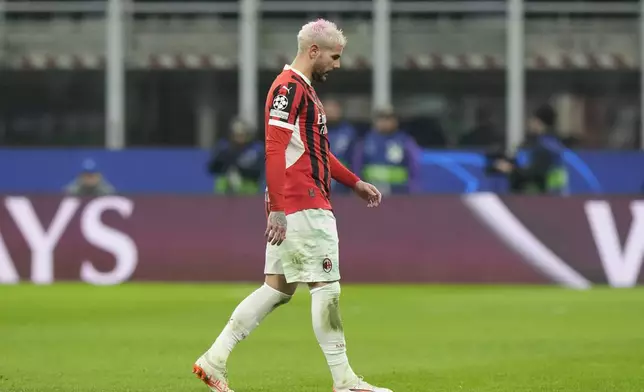 AC Milan's Theo Hernandez leaves the pitch after being sent off by Referee Szymon Marciniak of Poland after his second yellow card during Champions League, playoff second leg soccer match between AC Milan and Feyenoord, at the San Siro stadium in Milan, Italy, Tuesday, Feb.18, 2025. (AP Photo/Luca Bruno)