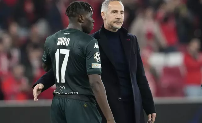 Monaco's head coach Adi Huetter, right, speaks with Monaco's Wilfried Singo at the end of the Champions League playoff second leg soccer match between SL Benfica and AS Monaco at the Luz stadium in Lisbon, Tuesday, Feb. 18, 2025. (AP Photo/Armando Franca)