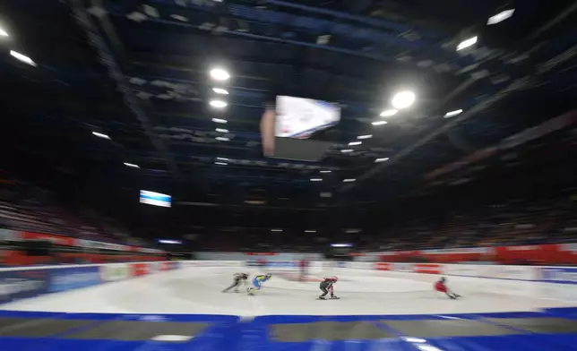 Athletes compete during men's preliminaries round of the ISU Short Track World Tour, Olympics Milano-Cortina 2026 test event, in Milan, Italy, Friday, Feb. 14, 2025. (AP Photo/Luca Bruno)