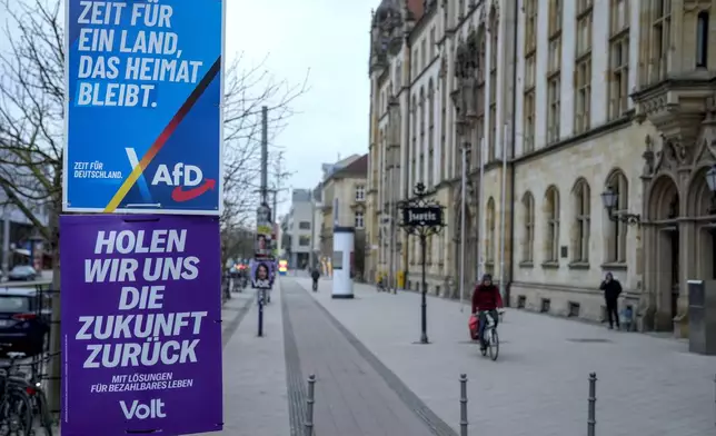 An election poster of the far-right anti-immigrant party Alternative For Germany party AfD, with with the slogan reading "It's time for a country that is still a home country", is displayed in a street, in Magdeburg, Germany, Friday, Feb. 7, 2025. (AP Photo/Ebrahim Noroozi)