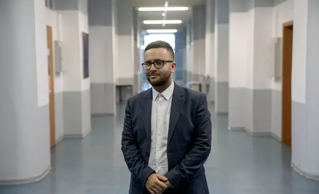 Saeeid Saeeid, 25 years old Syrian immigrant who has lived and worked in Magdeburg for 6 years, poses for a photo in a street, in Magdeburg, Germany, Friday, Feb. 7, 2025. (AP Photo/Ebrahim Noroozi)