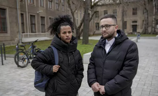 Haben Gebregergish, 26, Eritrean immigrant who has lived and worked in Magdeburg for 7 years, left, and Saeeid Saeeid, 25, Syrian immigrant who has lived and worked in Magdeburg for 6 years stand for a photo in a street, in Magdeburg, Germany, Friday, Feb. 7, 2025. (AP Photo/Ebrahim Noroozi)