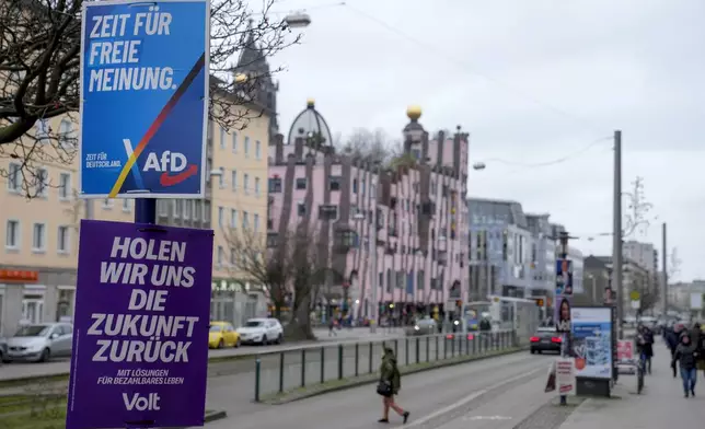 An election poster of the far-right anti-immigrant party Alternative For Germany party AfD, with the slogan reading "It's time for free opinion, is displayed in a street, in Magdeburg, Germany, Friday, Feb. 7, 2025. (AP Photo/Ebrahim Noroozi)
