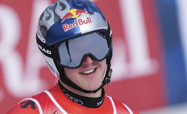 Switzerland's Franjo von Allmen celebrates at the finish area of a men's downhill race, at the Alpine Ski World Championships, in Saalbach-Hinterglemm, Austria, Sunday, Feb. 9, 2025. (AP Photo/Giovanni Auletta)