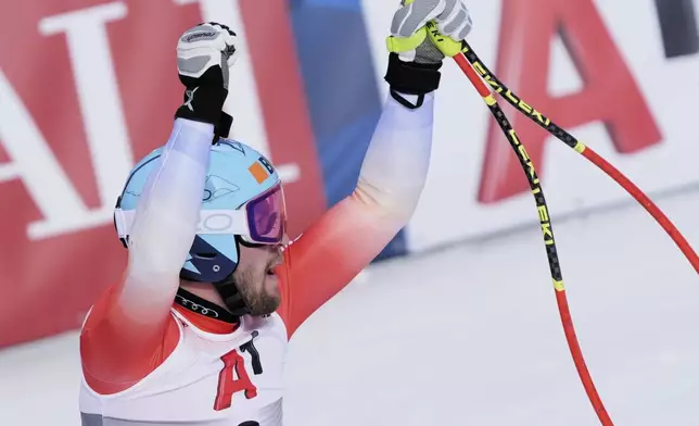 Switzerland's Alexis Monney celebrates at the finish area of a men's downhill race, at the Alpine Ski World Championships, in Saalbach-Hinterglemm, Austria, Sunday, Feb. 9, 2025. (AP Photo/Giovanni Auletta)