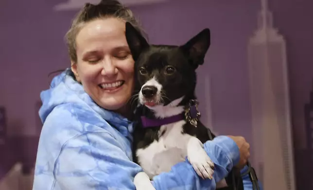 Katrina Wallace poses for a photo with her mixed breed, Beatrice, at the 149th Westminster Kennel Club Dog show, Saturday, Feb. 8, 2025, in New York. (AP Photo/Heather Khalifa)