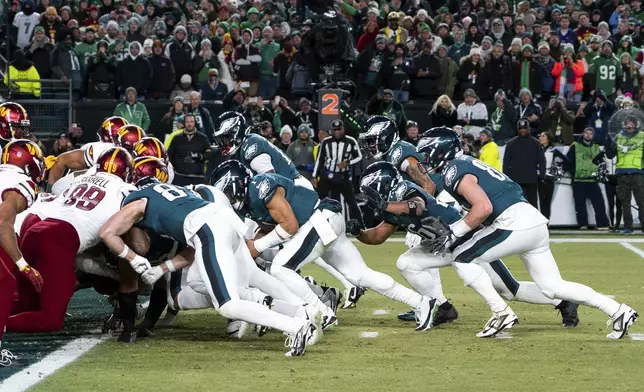 FILE - Philadelphia Eagles quarterback Jalen Hurts, center, and teammates run the tush push play during the NFL championship playoff football game against the Washington Commanders, Sunday, Jan. 26, 2025, in Philadelphia. (AP Photo/Chris Szagola, FIle)