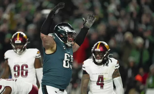 Philadelphia Eagles offensive tackle Lane Johnson (65) celebrates a touchdown by quarterback Jalen Hurts during the second half of the NFC Championship NFL football game against the Washington Commanders, Sunday, Jan. 26, 2025, in Philadelphia. (AP Photo/Derik Hamilton)