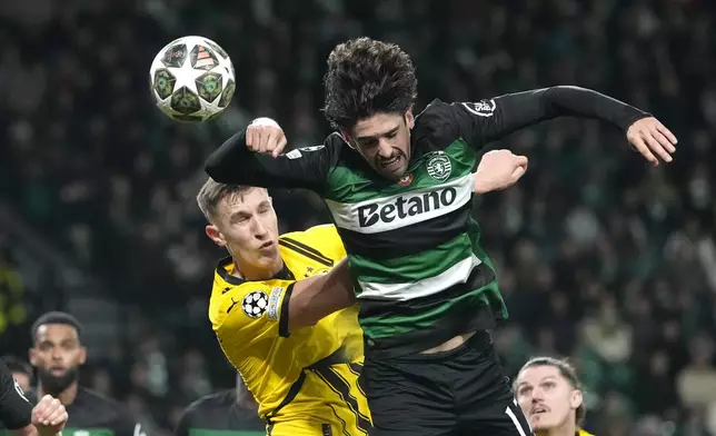 Dortmund's Nico Schlotterbeck, left, challenges for the ball with Sporting's Francisco Trincao during the Champions League playoff first leg soccer match between Sporting CP and Borussia Dortmund at the Alvalade stadium in Lisbon, Portugal, Tuesday, Feb. 11, 2025. (AP Photo/Armando Franca)