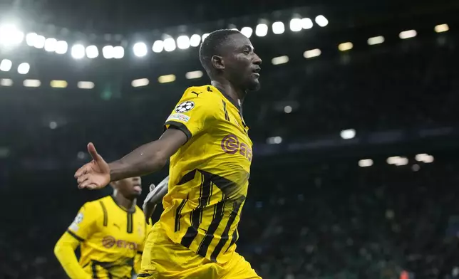 Dortmund's Serhou Guirassy celebrates after scoring his side's opening goal during the Champions League playoff first leg soccer match between Sporting CP and Borussia Dortmund at the Alvalade stadium in Lisbon, Portugal, Tuesday, Feb. 11, 2025. (AP Photo/Armando Franca)
