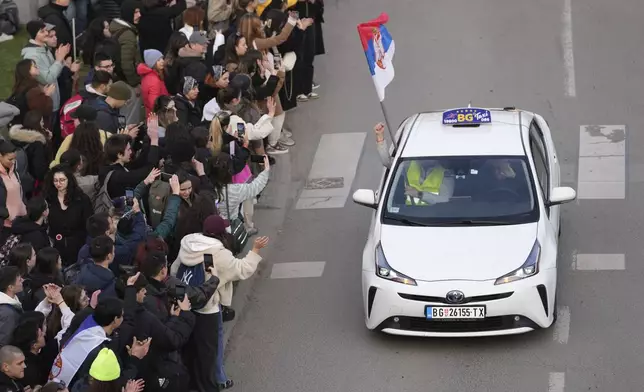 A taxi driver arrives to bring students back to Belgrade after a protest over the collapse of a concrete canopy that killed 15 people more than two months ago, in Novi Sad, Serbia, Sunday, Feb. 2, 2025. (AP Photo/Darko Vojinovic)