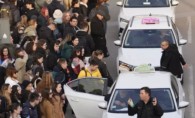 A taxi driver arrives to bring students back to Belgrade after a protest over the collapse of a concrete canopy that killed 15 people more than two months ago, in Novi Sad, Serbia, Sunday, Feb. 2, 2025. (AP Photo/Darko Vojinovic)