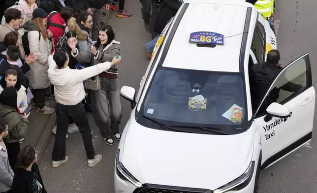 A taxi driver arrives to bring students back to Belgrade after a protest over the collapse of a concrete canopy that killed 15 people more than two months ago, in Novi Sad, Serbia, Sunday, Feb. 2, 2025. (AP Photo/Darko Vojinovic)