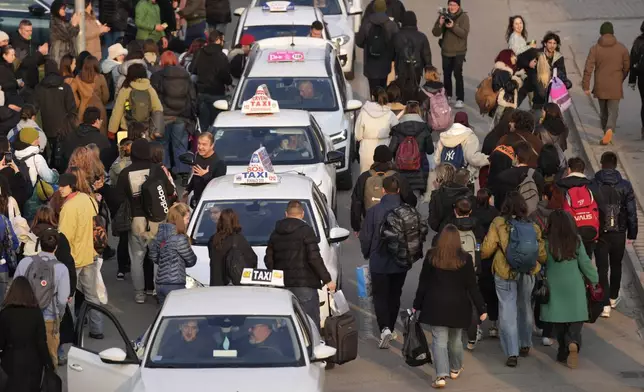 A taxi driver arrives to bring students back to Belgrade after a protest over the collapse of a concrete canopy that killed 15 people more than two months ago, in Novi Sad, Serbia, Sunday, Feb. 2, 2025. (AP Photo/Darko Vojinovic)