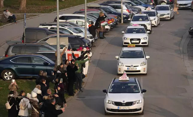 A taxi driver arrives to bring students back to Belgrade after a protest over the collapse of a concrete canopy that killed 15 people more than two months ago, in Novi Sad, Serbia, Sunday, Feb. 2, 2025. (AP Photo/Darko Vojinovic)