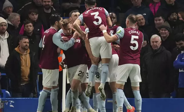 West Ham's Jarrod Bowen (20) celebrates with team mates after scoring his side's opening goal during the English Premier League soccer match between Chelsea and West Ham United at Stamford Bridge stadium in London, Monday, Feb. 3, 2025. (AP Photo/Kirsty Wigglesworth)