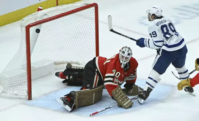 Toronto Maple Leafs left wing Nicholas Robertson scores a goal past Chicago Blackhawks goaltender Arvid Soderblom (40) during the second period of an NHL hockey game, Sunday, Feb. 23, 2025, in Chicago. (AP Photo/Matt Marton)